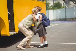 mama objema hčerko pred odhodom na šolski avtobus