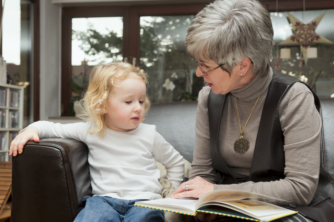 babica bere knjigo vnukinji